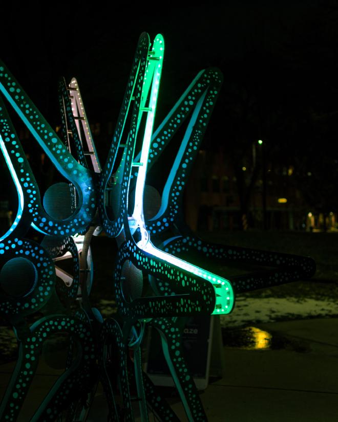 part of a metal 3D star-shaped sculpture with colorful led lights running through it